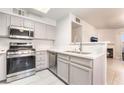 Modern kitchen features stainless steel appliances, white marble counters, and updated fixtures at 3066 Tarpon Dr # 204, Las Vegas, NV 89120