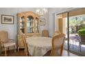 Elegant dining room with a china cabinet, seating for six, and a view to the backyard at 3128 Faiss Dr, Las Vegas, NV 89134