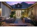 Charming front entrance with a brick pathway, lovely desert landscaping, and modern front door at 3131 Reverence Heights Ln, Las Vegas, NV 89138