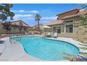 Inviting swimming pool with lounge chairs and lush greenery; your own private oasis at 349 Clayton St, Henderson, NV 89074
