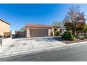 Single-story home with tile roof, two car garage, and low maintenance desert landscaping at 3816 Sunking St, Las Vegas, NV 89130