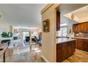 Open-concept living space features elegant tile floors, gourmet kitchen and comfortable living area at 3816 Sunking St, Las Vegas, NV 89130