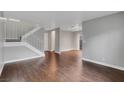Spacious living room showcasing hardwood floors, a staircase, and a neutral color palette at 4339 Spencer St # 15, Las Vegas, NV 89119