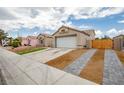 Charming home with low maintenance desert landscaping, two-car garage, and driveway at 6124 Desert Haven Rd, Las Vegas, NV 89130
