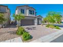 Inviting two-story home featuring manicured landscaping and a brick driveway leading to a spacious garage at 6442 Kobe Knoll Ct, Las Vegas, NV 89141