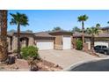 Inviting single-story home showcasing desert landscaping and a convenient three-car garage at 653 Paloma Cir, Mesquite, NV 89027