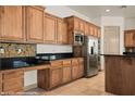 Well-equipped kitchen featuring stainless steel appliances, sleek granite countertops, and custom cabinets at 653 Paloma Cir, Mesquite, NV 89027