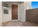 Inviting front entrance with a stone-paved porch and a stylish brown front door, ensuring a warm welcome at 6854 Chargehand Ave, Las Vegas, NV 89156