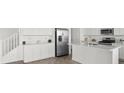 Bright kitchen featuring white cabinets, stainless steel appliances, and a kitchen island, perfect for cooking at 6854 Chargehand Ave, Las Vegas, NV 89156