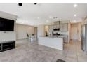 Spacious open-concept living room and kitchen featuring tile floors, modern appliances, recessed lighting, and a breakfast nook at 7246 Dazzle Point St, North Las Vegas, NV 89084