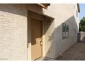 Close up view of the tan house with desert landscaping and a beige front door at 7570 Durham Hall Ave # 101, Las Vegas, NV 89130