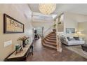 Grand foyer with soaring ceilings, chandelier, staircase, and tile flooring at 8104 Wispy Sage Way, Las Vegas, NV 89149