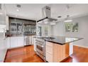Modern kitchen with stainless steel appliances, a large island, and dark countertops at 819 Bracken Ave, Las Vegas, NV 89104