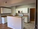 Kitchen features white cabinets and tiled flooring at 8250 N Grand Canyon Dr # 2029, Las Vegas, NV 89166