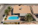Aerial view of a private backyard with a sparkling pool and covered patio area at 9091 W Viking Rd, Las Vegas, NV 89147
