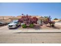 Inviting home exterior with mature trees and well-kept landscaping at 9091 W Viking Rd, Las Vegas, NV 89147