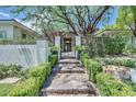 Inviting walkway through manicured hedges lead to the front door of this residence at 9500 Balatta Canyon Ct, Las Vegas, NV 89144
