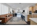 Open-concept living room flows into the kitchen, featuring hardwood floors and bright, natural light at 12429 Alpenglow Ct, Las Vegas, NV 89138