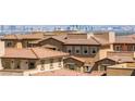 Rooftop view of community with terracotta roofing, desert landscaping and panoramic city views in the background at 160 Lomita Heights Dr, Las Vegas, NV 89138