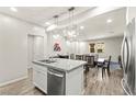 Beautiful open-concept kitchen with stainless steel appliances, island seating, and contemporary lighting fixtures at 160 Lomita Heights Dr, Las Vegas, NV 89138
