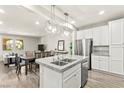 Modern kitchen with granite counters, stainless steel appliances, island and ample cabinet space at 160 Lomita Heights Dr, Las Vegas, NV 89138