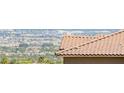View of a well maintained, tile roof overlooking a distant cityscape at 160 Lomita Heights Dr, Las Vegas, NV 89138