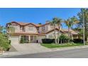 Traditional two-story home boasting a three-car garage, manicured lawn, and desert landscaping at 2388 Kenneth Ave, Henderson, NV 89052