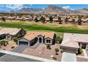 Picturesque aerial view of a home with a tile roof, desert landscaping, and a golf course in the background at 2625 Youngdale Dr, Las Vegas, NV 89134