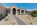 Close up of a charming single-story home with manicured desert landscaping and covered entry at 2625 Youngdale Dr, Las Vegas, NV 89134