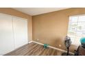 Bedroom with hardwood flooring, neutral walls, and double sliding-door closet at 2722 Sweet Basil Dr, Las Vegas, NV 89142