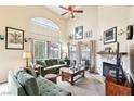 Spacious living room with large windows, fireplace, plush seating, and natural light at 2809 Du Barry Manor Ln, Las Vegas, NV 89108