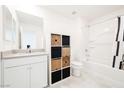 Well-lit bathroom featuring a tub, storage, and modern fixtures at 3240 Avernus Ave, Henderson, NV 89044