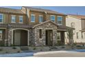 Charming townhome with a stone accented entryway, covered porch, and neatly arranged front yard at 3240 Avernus Ave, Henderson, NV 89044