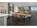 Bright, open-concept dining area with a sleek table and chairs, connecting to a cozy living space at 3426 Oristano Ln, Henderson, NV 89044
