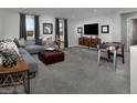 Comfortable game room featuring a plush sectional sofa and entertainment area with a TV and game table at 3426 Oristano Ln, Henderson, NV 89044