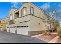 Beige stucco two-story condo with garage parking and minimal landscaping at 3936 Pepper Thorn Ave # 102, North Las Vegas, NV 89081