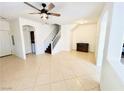 Bright living room featuring tile flooring, staircase and ceiling fan at 3936 Pepper Thorn Ave # 102, North Las Vegas, NV 89081