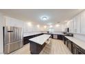 Spacious kitchen featuring an island, stainless steel appliances, granite countertops, and white cabinets at 3950 Oakridge Ave, Pahrump, NV 89048
