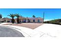 Charming single-story home featuring solar panels, desert landscaping, and a spacious curved driveway at 4119 Meadowglen Cir, Las Vegas, NV 89121