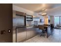 Contemporary kitchen featuring stainless steel appliances, bar seating, and a stylish, minimalist design at 4381 W Flamingo Rd # 3818, Las Vegas, NV 89103