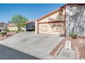 A long driveway leading to a two-car garage in a well maintained community at 5242 Dickens Dr, Las Vegas, NV 89119