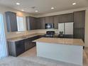 Modern kitchen with granite countertops, stainless steel appliances, and a central island at 5817 Bonita Rose St, Las Vegas, NV 89113