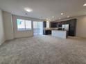 Spacious living room and modern kitchen with stainless steel appliances and island at 5817 Bonita Rose St, Las Vegas, NV 89113