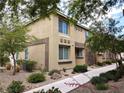Beautiful two-story townhome with stone accents, mature trees, and low-maintenance landscaping at 6168 Scarlet Leaf St, Las Vegas, NV 89148