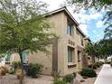 Side view of a two-story home showcasing manicured landscaping and desert foliage at 6168 Scarlet Leaf St, Las Vegas, NV 89148