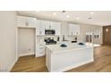 Well-equipped kitchen with white cabinetry, stainless steel appliances, gas range, and large island with a white countertop at 6388 Canyon Dawn Ave, Las Vegas, NV 89108