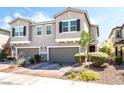 Attractive townhome with a two-car garage and manicured front yard landscaping at 6650 Drusilla St, North Las Vegas, NV 89084
