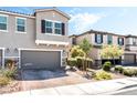 Inviting two-story townhome featuring a paved driveway and well-maintained landscaping at 6650 Drusilla St, North Las Vegas, NV 89084