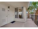 Unit 303 front porch with a white door, black hardware, and space for outdoor seating at 7119 S Durango Dr # 303, Las Vegas, NV 89113