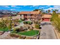 Charming two-story home with mature trees, a stone walkway, and a red-tiled roof at 7470 Eldora Av, Las Vegas, NV 89117